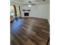 Bright living room featuring modern flooring, fireplace, and natural light, ideal for relaxation and entertainment at 4906 Kellys Mill Nw Dr, Lilburn, GA 30047
