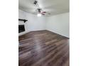 Spacious living room featuring modern flooring, a cozy fireplace, and a ceiling fan for added comfort at 4906 Kellys Mill Nw Dr, Lilburn, GA 30047