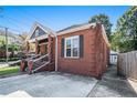 Brick exterior of a charming home highlighting the driveway and quaint architectural details at 50 Ormond Sw St, Atlanta, GA 30315