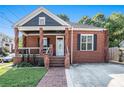 Classic brick home with a welcoming front porch, well-maintained lawn, and a quaint, inviting entrance at 50 Ormond Sw St, Atlanta, GA 30315