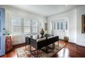 Bright dining room with hardwood floors and large windows offering natural light and outdoor views at 1923 Rugby Ave, Atlanta, GA 30337