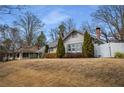 Well-maintained home with a spacious yard and mature trees, offering privacy and curb appeal at 1923 Rugby Ave, Atlanta, GA 30337