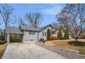 Charming single-Gathering home with a spacious front yard, a driveway with a carport, and traditional landscaping at 1923 Rugby Ave, Atlanta, GA 30337