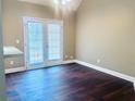 Living room with hardwood floors, high ceilings, French doors, and plenty of natural light at 4415 Yates Rd, Atlanta, GA 30337
