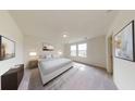 Relaxing primary bedroom with plush carpet, a large window, and elegant decor at 7728 Sudbury Cir, Covington, GA 30014
