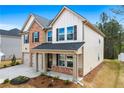 Beautiful two-story home featuring a brick front, double garage, and covered front porch at 1645 Fuma Leaf Way, Mcdonough, GA 30253