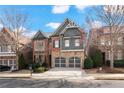 Attractive two-story home featuring brick, stone, and gray shingle siding and a two-car garage at 13029 Dartmore Ave, Alpharetta, GA 30005