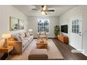Cozy staged living room with neutral tones, plush seating, and natural light at 2399 Coach Way, Jonesboro, GA 30236