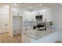 Bright kitchen with modern design, showcasing the counter space, cabinets, and stainless steel appliances at 2414 Rose Palm Pl, Atlanta, GA 30315