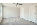 Spacious bedroom with neutral carpet, a ceiling fan, and natural light at 480 Rockwell Sw St, Atlanta, GA 30310