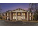 Exterior of a residential building featuring stately columns and a dusk sky, creating an inviting curb appeal at night at 135 E Hill St # 24, Decatur, GA 30030