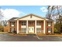 Classic brick exterior of a residential building featuring stately columns and well-maintained landscaping for a welcoming curb appeal at 135 E Hill St # 24, Decatur, GA 30030