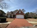 Beautiful brick home featuring a brick driveway and well-maintained lawn at 2392 Ivy Mountain Dr, Snellville, GA 30078