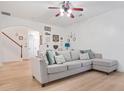 Bright living room with decorative wall art, modern ceiling fan, and comfortable sectional sofa at 2521 Capella Sw Cir, Atlanta, GA 30331