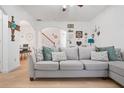 Inviting living room featuring a comfortable gray sofa and stylish decorative wall hangings at 2521 Capella Sw Cir, Atlanta, GA 30331