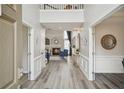 Elegant foyer with hardwood floors, a view of the staircase, and an open view into the living room at 2615 Springmonte Pl, Cumming, GA 30041
