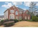 Lovely two-story brick home with neat landscaping and a well-maintained lawn at 2615 Springmonte Pl, Cumming, GA 30041