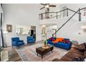 Bright living room features a high ceiling, large windows, and comfortable furnishings at 2615 Springmonte Pl, Cumming, GA 30041
