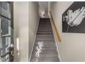 Carpeted stairway leads to the upper level, complemented by a wooden handrail at 612 Vinings Estates Se Dr # B12, Smyrna, GA 30126