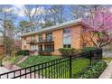 A brick apartment building surrounded by greenery at 1235 Woodland Ne Ave # 1, Atlanta, GA 30324