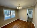Dining area with hardwood floors, a bright window, and views into kitchen at 371 Landers Sw Dr, Mableton, GA 30126