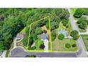 Aerial shot showcasing the property's boundaries, surrounded by mature trees and well-maintained landscaping at 4184 Wyndham Park Way, Buford, GA 30519