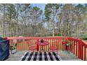 Cozy back deck with a red table and chairs, perfect for enjoying the outdoors at 4184 Wyndham Park Way, Buford, GA 30519