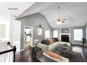Bright living room features vaulted ceilings, hardwood floors, fireplace, and open layout at 4184 Wyndham Park Way, Buford, GA 30519