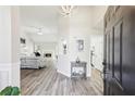 Bright entryway featuring an open floorplan, wood floors, and modern lighting leading into the living space at 1925 Meyers Dr, Lawrenceville, GA 30045