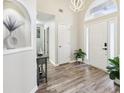 Open entryway with high ceilings, light hardwood floors, a decorative niche, and modern light fixtures at 1925 Meyers Dr, Lawrenceville, GA 30045