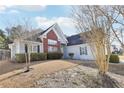 Exterior view of a light blue house, showing a brick feature and winter landscaping around the property at 1925 Meyers Dr, Lawrenceville, GA 30045