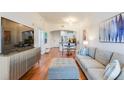 Open-concept living area with hardwood floors, comfortable seating, and a view of the kitchen at 2277 Peachtree Ne Rd # 608, Atlanta, GA 30309