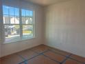 Bedroom with large window offering neighborhood views and plenty of natural light at 630 Gilles Ln, Cumming, GA 30041