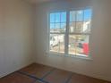 Bright bedroom featuring a large window with views of the surrounding neighborhood at 630 Gilles Ln, Cumming, GA 30041