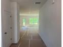 Bright hallway leading to a spacious living area, with natural light pouring in through the windows at 630 Gilles Ln, Cumming, GA 30041
