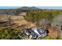 Sprawling property featuring a home with a large yard, trees, pond, and mountain views at 1325 Whitlock Sw Ave, Marietta, GA 30064