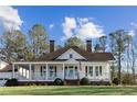 Classic home with a cozy front porch, painted in white, under a clear blue sky at 1325 Whitlock Sw Ave, Marietta, GA 30064