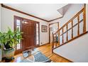 Bright foyer features hardwood floors, a wooden staircase, and a decorative rug, creating an inviting entrance at 1532 Boxwood Nw Trce, Acworth, GA 30102