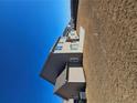 Back exterior of a two-story home featuring tan siding, lots of windows, and a spacious yard at 3671 Casual Ridge Way, Loganville, GA 30052
