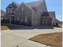 Two car garage with a concrete drive and beautiful brick and siding at 3671 Casual Ridge Way, Loganville, GA 30052