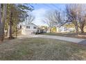 Split-level home on a sunny day with an extended driveway and lush surroundings at 916 Marshall Fuller Rd, Dallas, GA 30157