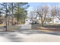 A long driveway leads up to this lovely split-level home, surrounded by mature trees at 916 Marshall Fuller Rd, Dallas, GA 30157