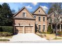 Charming brick home featuring a two-car garage, manicured lawn, and classic architectural details at 1837 Haven Park Se Cir, Smyrna, GA 30080