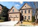 Charming brick home featuring a two-car garage, manicured lawn, and classic architectural details at 1837 Haven Park Se Cir, Smyrna, GA 30080