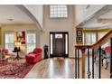 Bright foyer with hardwood floors, high ceilings, and a view of the living area at 2730 Henderson Chase Ct, Tucker, GA 30084