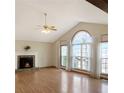 Bright living room with a stone fireplace, vaulted ceiling, and large windows offering plenty of natural light at 610 Coolsprings Ln, Woodstock, GA 30188