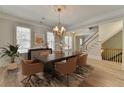 Elegant dining room featuring a wooden table, modern chairs, and natural light, ideal for gatherings and meals at 2110 Se Murren Se Dr, Smyrna, GA 30080