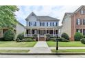 Charming two-story home featuring a welcoming front porch, blue shutters, and well-manicured landscaping at 2110 Se Murren Se Dr, Smyrna, GA 30080