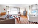 Sun-filled living room showcasing hardwood floors, stylish furnishings, and an abundance of natural light through large windows at 3551 Dial Dr, Stone Mountain, GA 30083