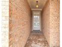 Close-up of the brick-lined entrance hallway leading to the front door at 498 Townsend St, Grayson, GA 30017